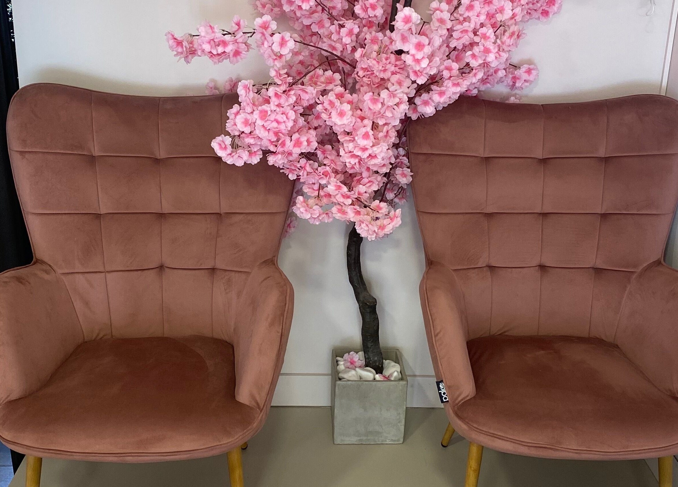 Cozy brown chairs and cherry blossom decor at Glow It, Limenas Chersonisou, GR.