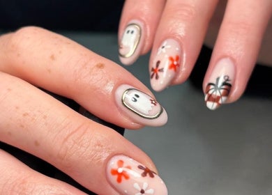 Unique Halloween nail art at Salon 17, Tamworth, England, GB showcasing ghost and floral designs.