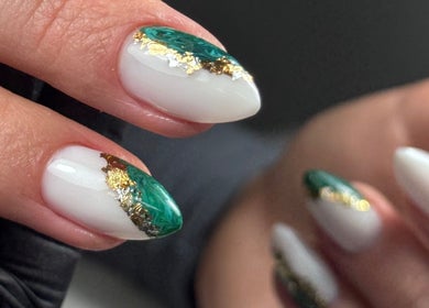 Detailed view of a Russian manicure by Julia Batalova in New York, New York, US, featuring green and gold accents.