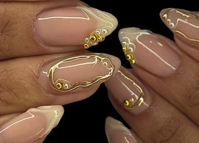 Close-up of glossy nails with gold accents at DARKA, Cheltenham, Victoria, AU.