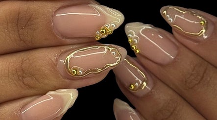 Close-up of glossy nails with gold accents at DARKA, Cheltenham, Victoria, AU.
