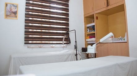 Tranquil treatment room at Xqisite Medspa & Salon, Benin City, Edo, NG, featuring spa beds and calming decor.