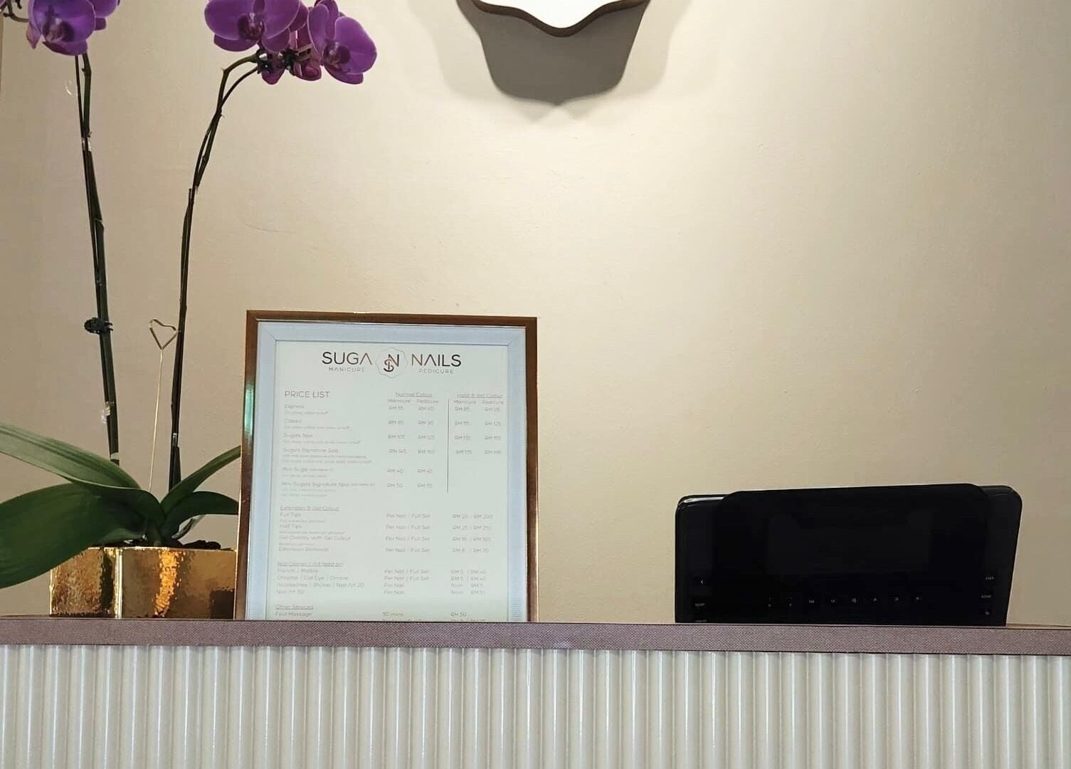 Elegant orchid and service menu at SugaNails KL reception, Ampang, Selangor, MY.