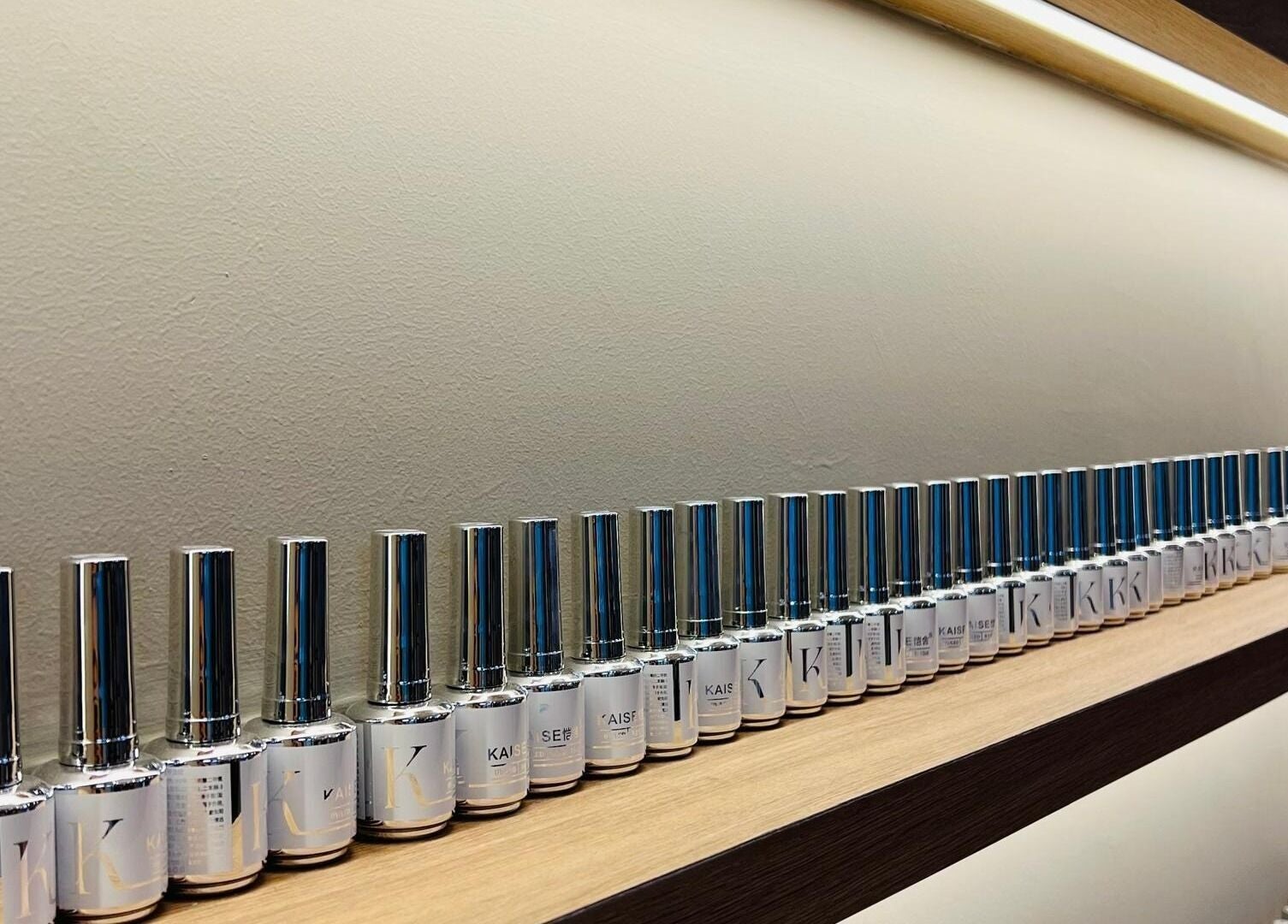 SugaNails KL, Ampang, Selangor displays a refined row of nail polishes, showcasing style and color variety.