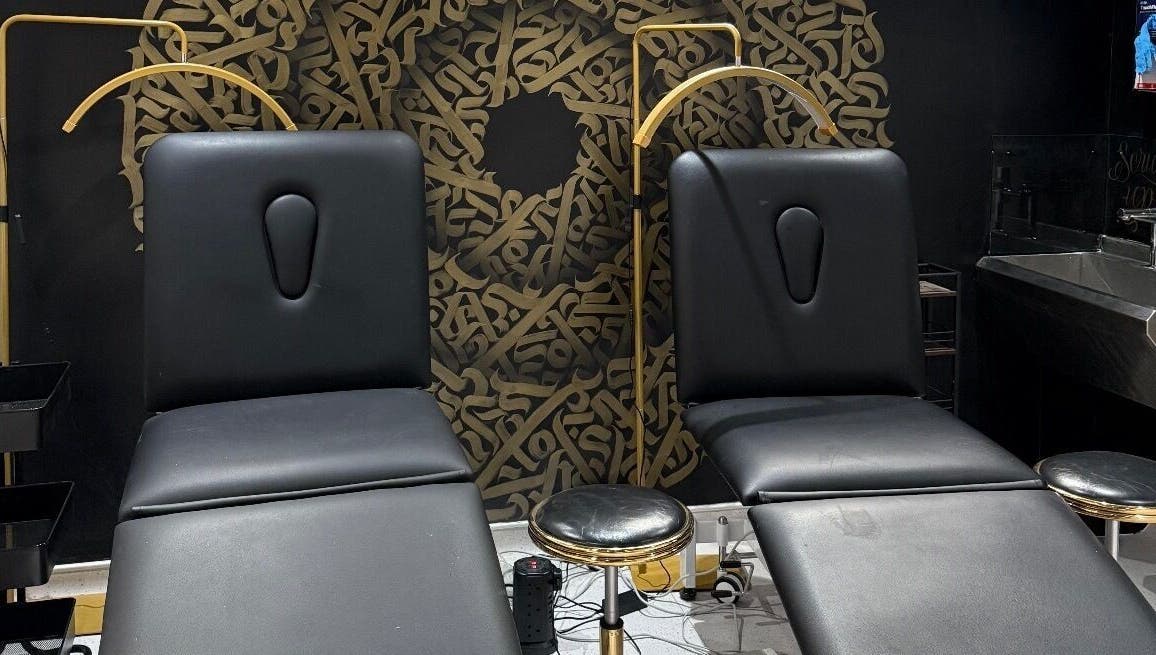 Luxury treatment chairs at Clinic 103 in Harpenden, England, GB with artistic black and gold decor.
