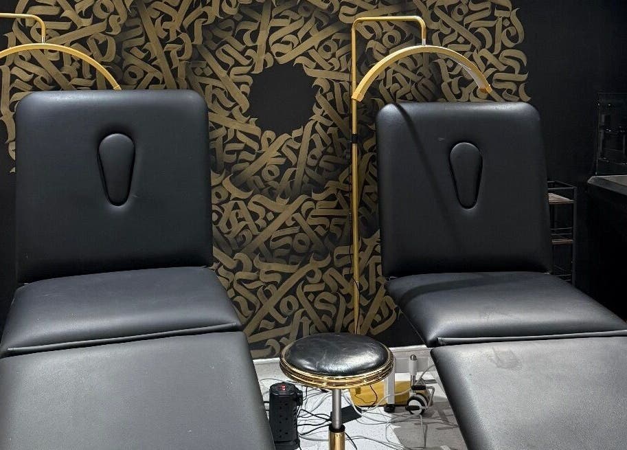 Luxury treatment chairs at Clinic 103 in Harpenden, England, GB with artistic black and gold decor.