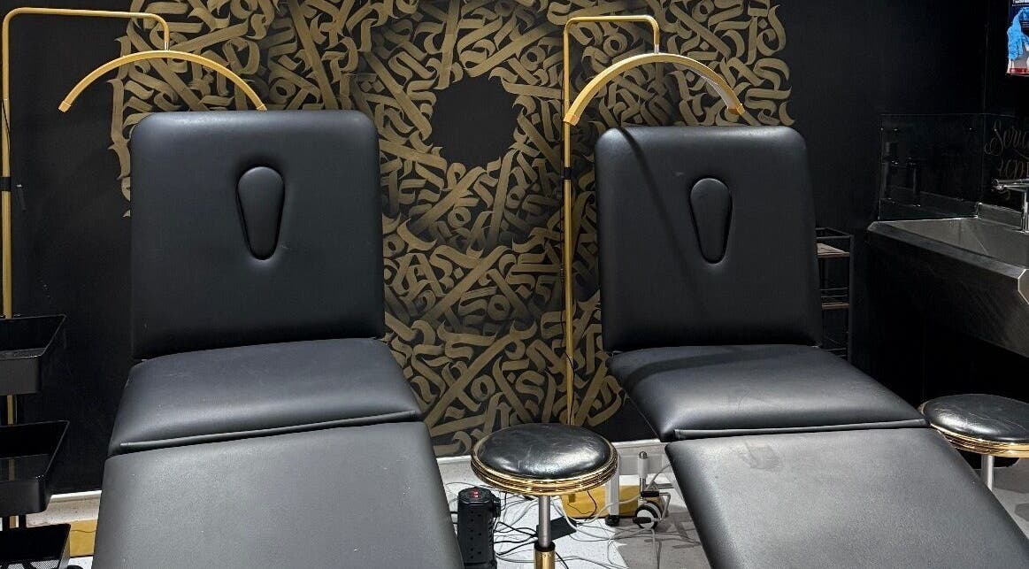 Luxury treatment chairs at Clinic 103 in Harpenden, England, GB with artistic black and gold decor.
