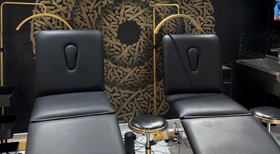 Luxury treatment chairs at Clinic 103 in Harpenden, England, GB with artistic black and gold decor.