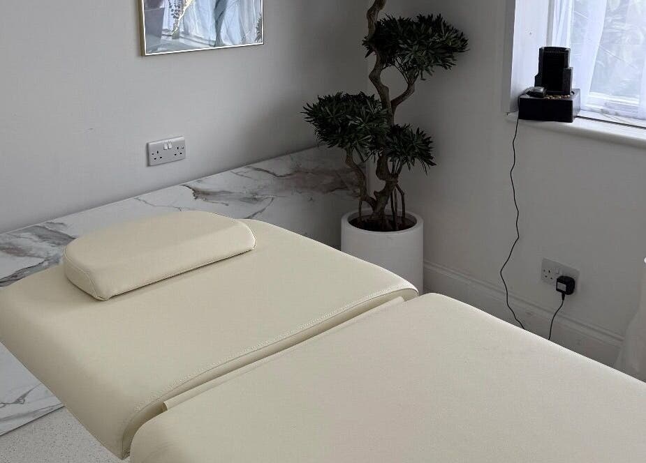 Relaxing treatment room at Clinic 103 in Harpenden, England, GB, featuring a comfortable massage table and calming decor.