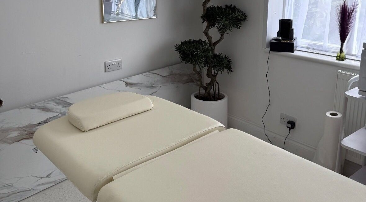 Relaxing treatment room at Clinic 103 in Harpenden, England, GB, featuring a comfortable massage table and calming decor.