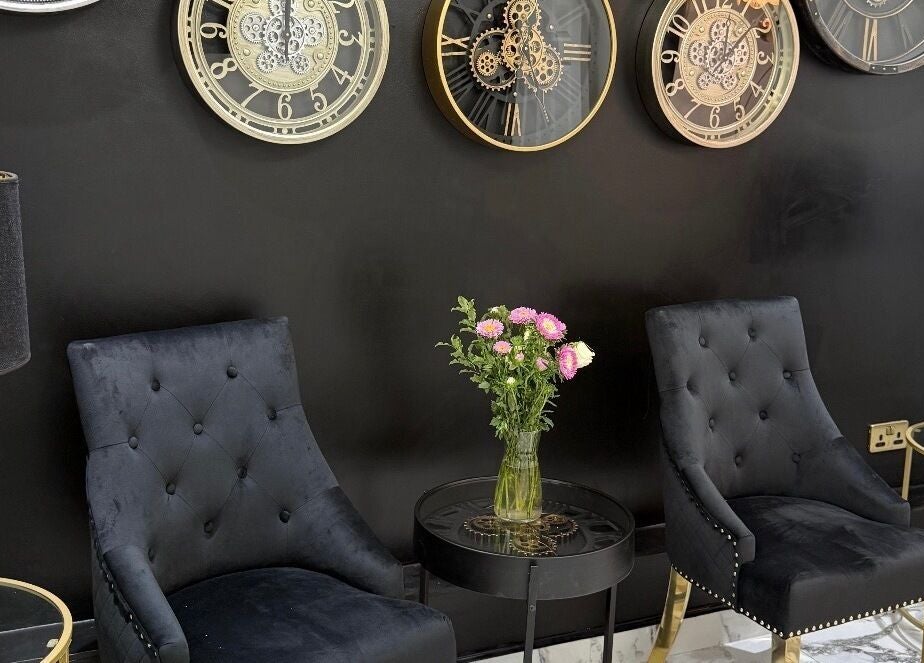 Luxurious black lounge chairs and floral decor at Clinic 103, Harpenden, England, GB, exude sophistication.