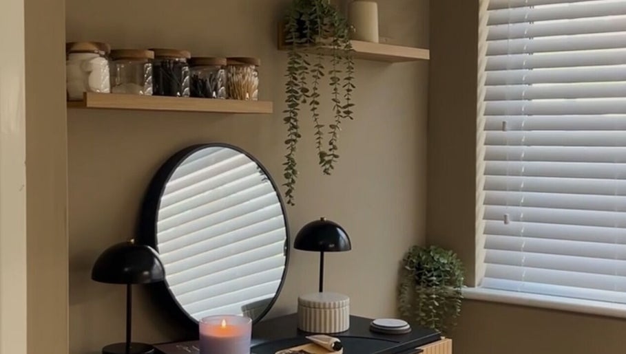 Elegant beauty corner at SH Beauty, Andover, England, GB showcasing a mirror and candle.