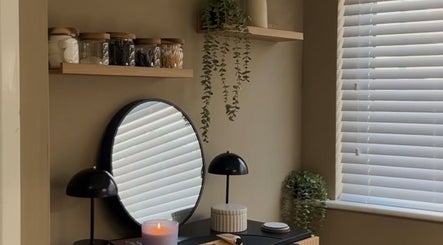 Elegant beauty corner at SH Beauty, Andover, England, GB showcasing a mirror and candle.