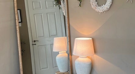 Elegant corner with mirror and lamp in SH Beauty, Andover, England, GB creating a warm, inviting ambiance.