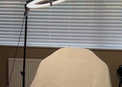 Relaxing treatment room at SH Beauty in Andover, England, GB, featuring soft light and comfy bed.