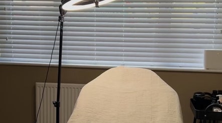 Relaxing treatment room at SH Beauty in Andover, England, GB, featuring soft light and comfy bed.