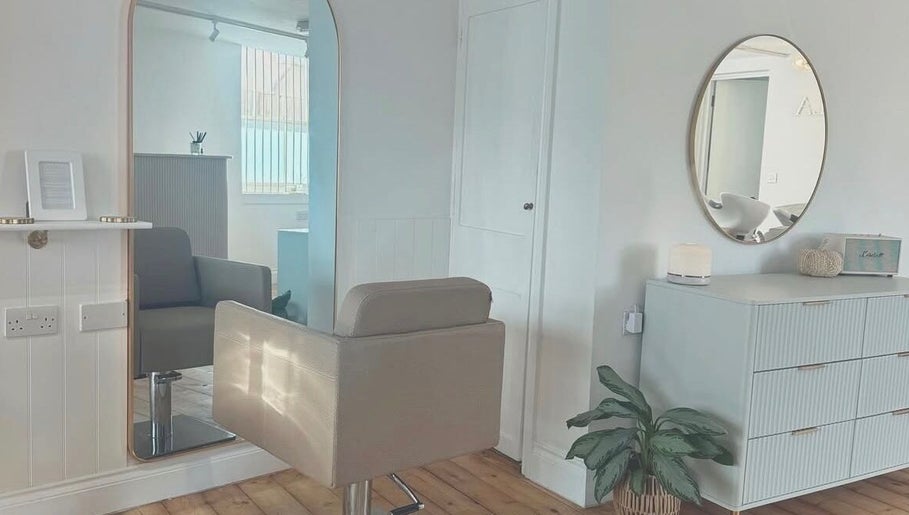 Chic hair salon interior at IsabelleRose.Hair, Ipswich, England, GB with stylish mirror and comfortable chair.