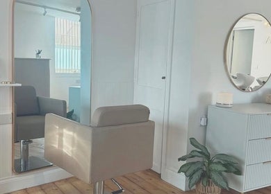 Chic hair salon interior at IsabelleRose.Hair, Ipswich, England, GB with stylish mirror and comfortable chair.