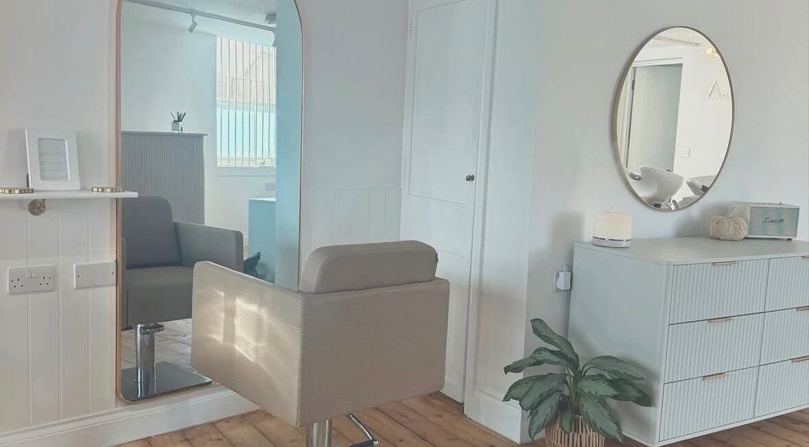 Chic hair salon interior at IsabelleRose.Hair, Ipswich, England, GB with stylish mirror and comfortable chair.