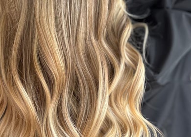 Stylish wavy blonde hair at IsabelleRose.Hair in Ipswich, England, GB. Perfect for a fresh look.