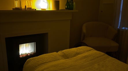 Relaxing room at Body Therapy Studio, Melbourne, Victoria, AU with warm lighting and a snug chair.