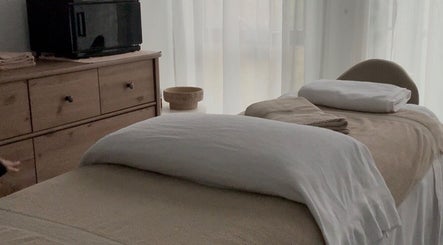 Relaxing massage room at Body Therapy Studio, Melbourne, Victoria, AU with a cozy treatment table and soft lighting.