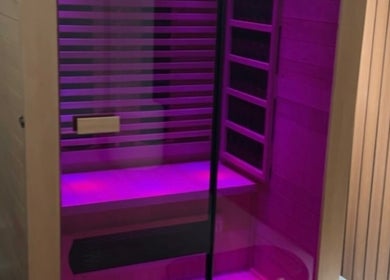 Relaxing infrared sauna at Body Therapy Studio, Melbourne, Victoria, AU with ambient purple lighting.