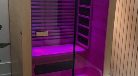 Relaxing infrared sauna at Body Therapy Studio, Melbourne, Victoria, AU with ambient purple lighting.