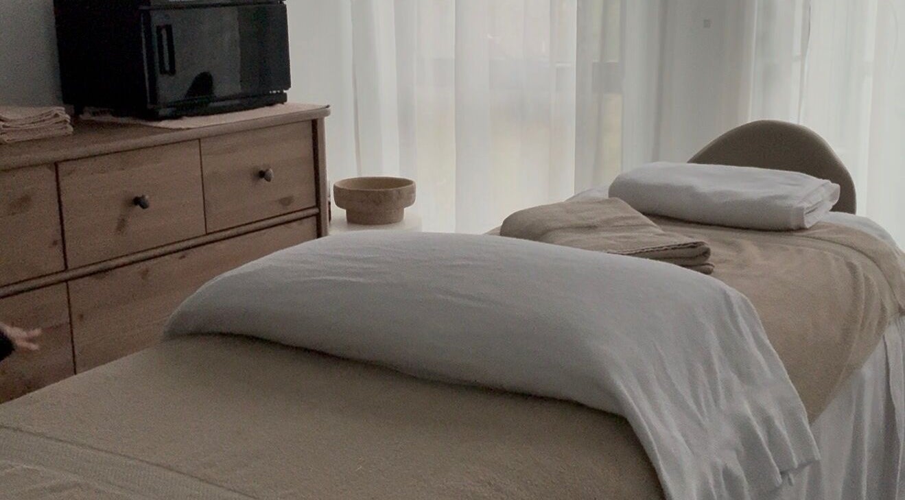 Tranquil massage room at Body Therapy Studio, Melbourne, Victoria, AU, featuring a cozy massage bed and linens.