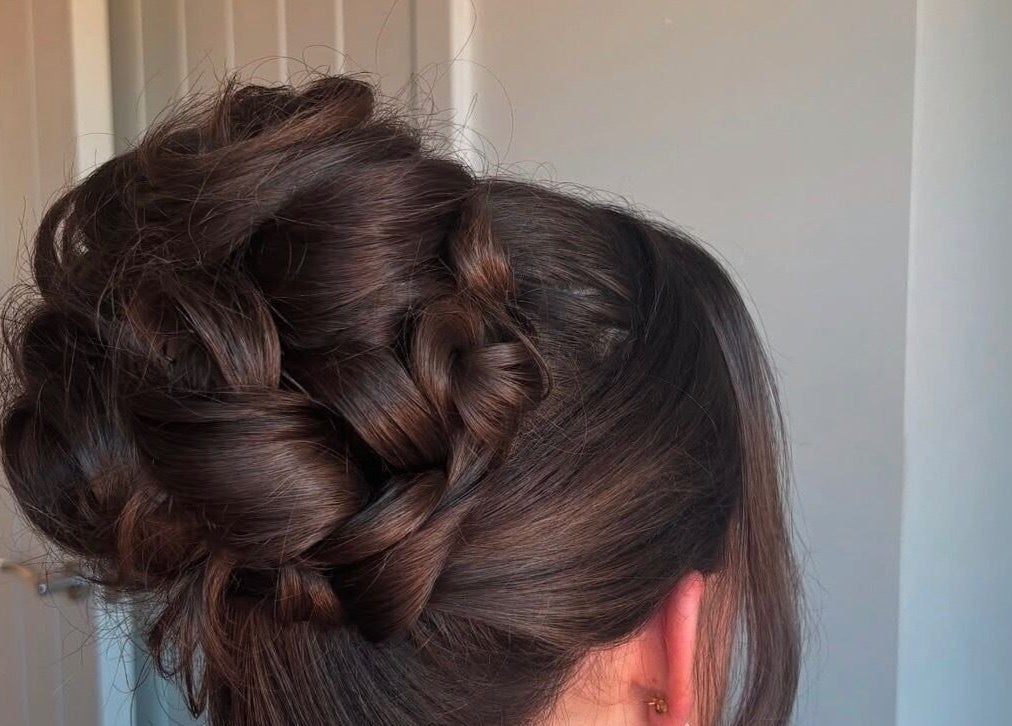 Sophisticated braided updo hairstyle at Revamp Studios, Ashington, England, GB.