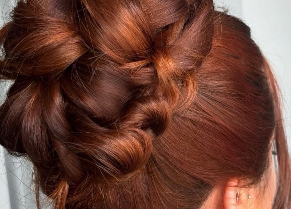 Intricate braided updo hairstyle at Revamp Studios, Ashington, England, GB enhances beauty and elegance.