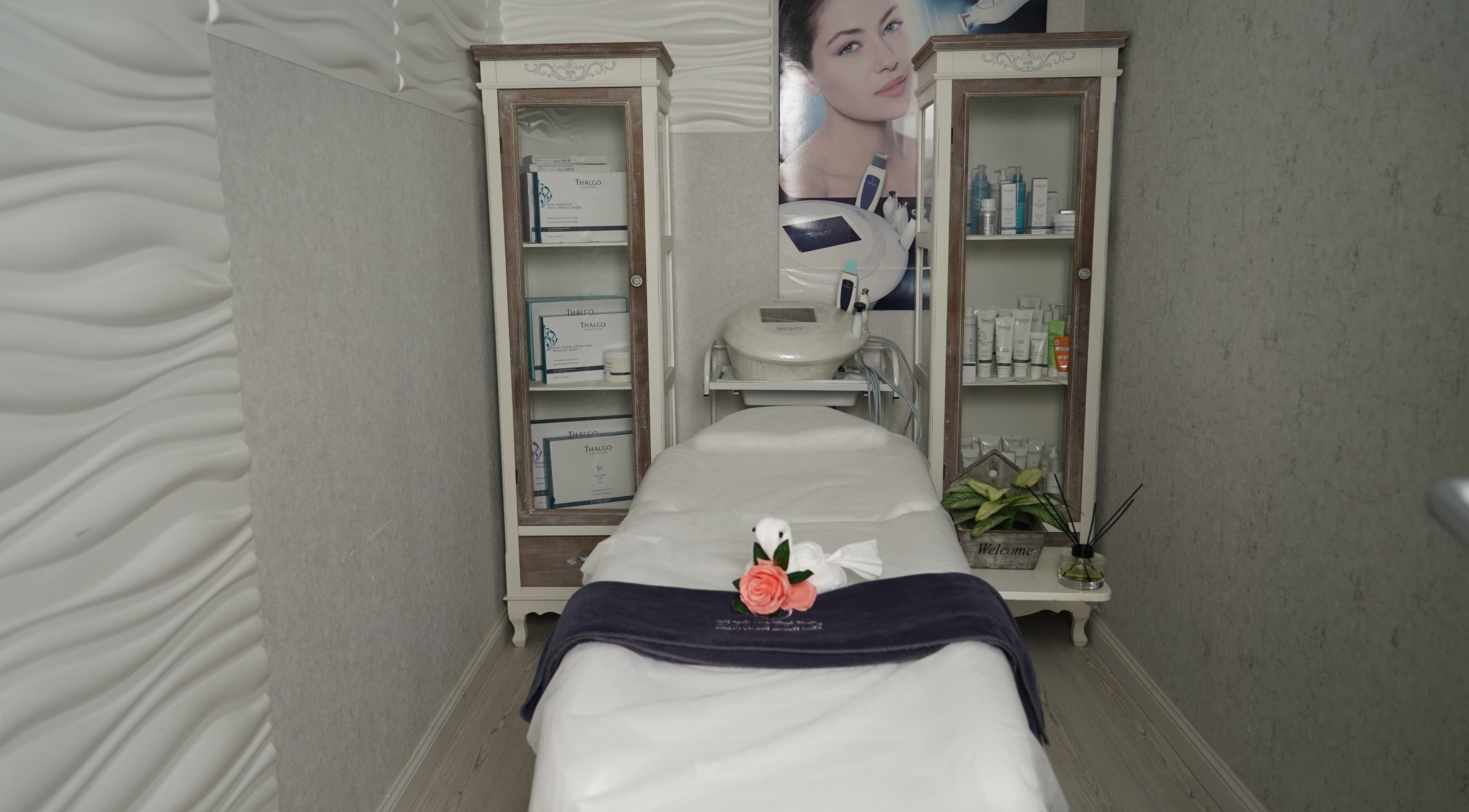 Elegant treatment room at Maid Hassan Beauty Center, Tarut, Eastern Province, SA, featuring spa bed and skincare products.