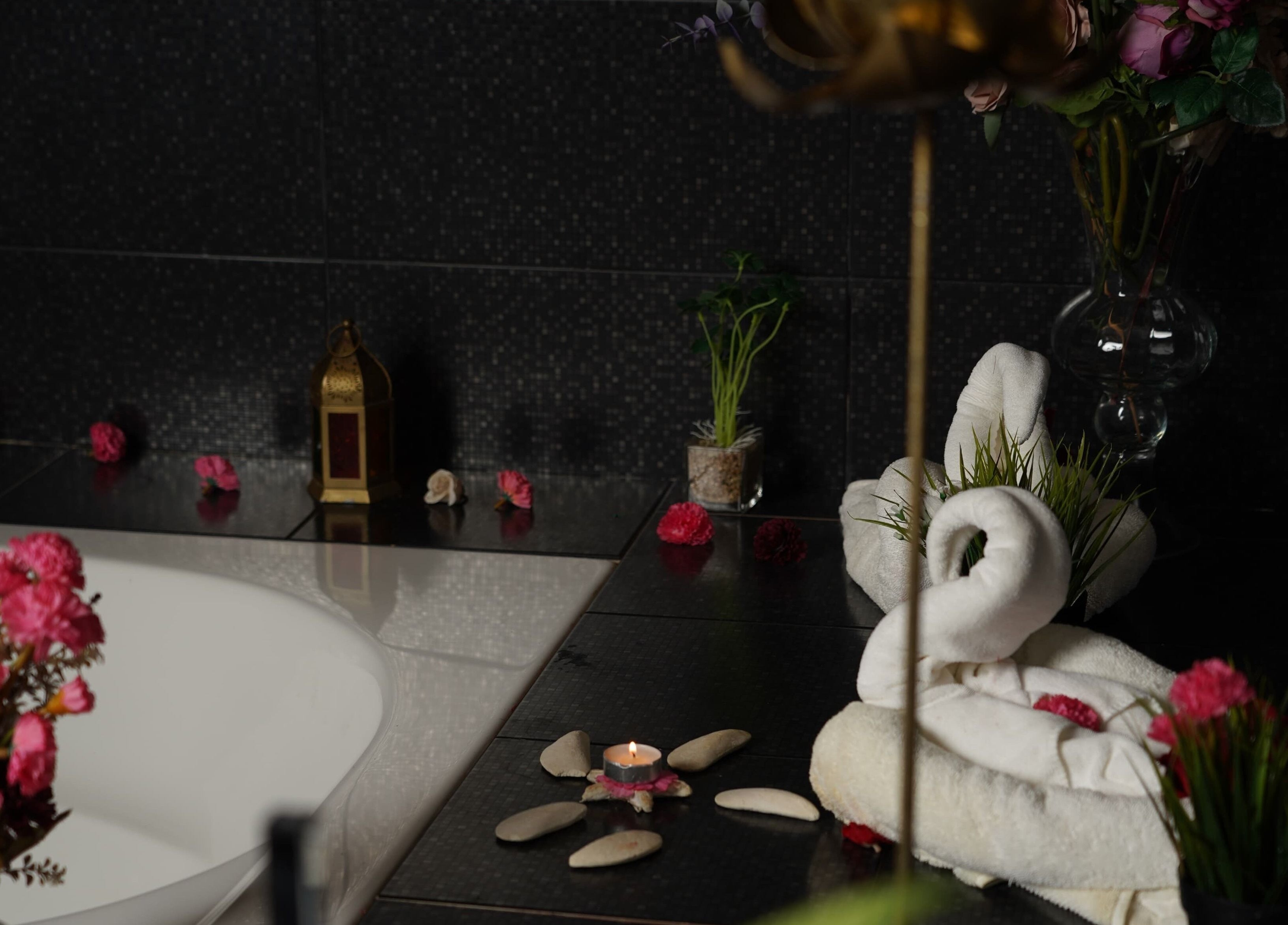 Luxurious spa setup at Maid Hassan Beauty Center, Tarut, Eastern Province, SA with candles and flowers.