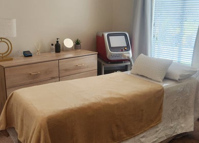 Tranquil treatment room at barewithtea_laser_studio, Randburg, Gauteng, ZA, featuring a cozy bed and laser equipment.