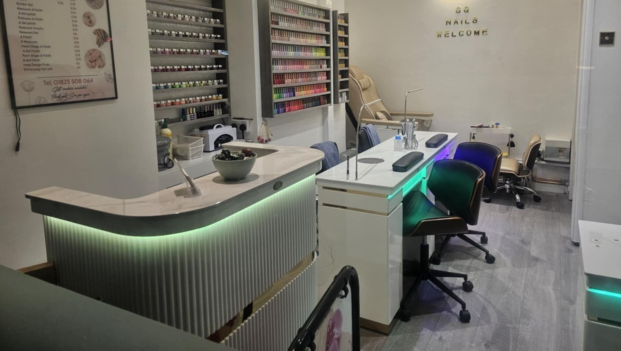 Elegant interior of Gg Nails Rottingdean, Brighton And Hove, England, GB showcasing nail polish display and manicure stations.