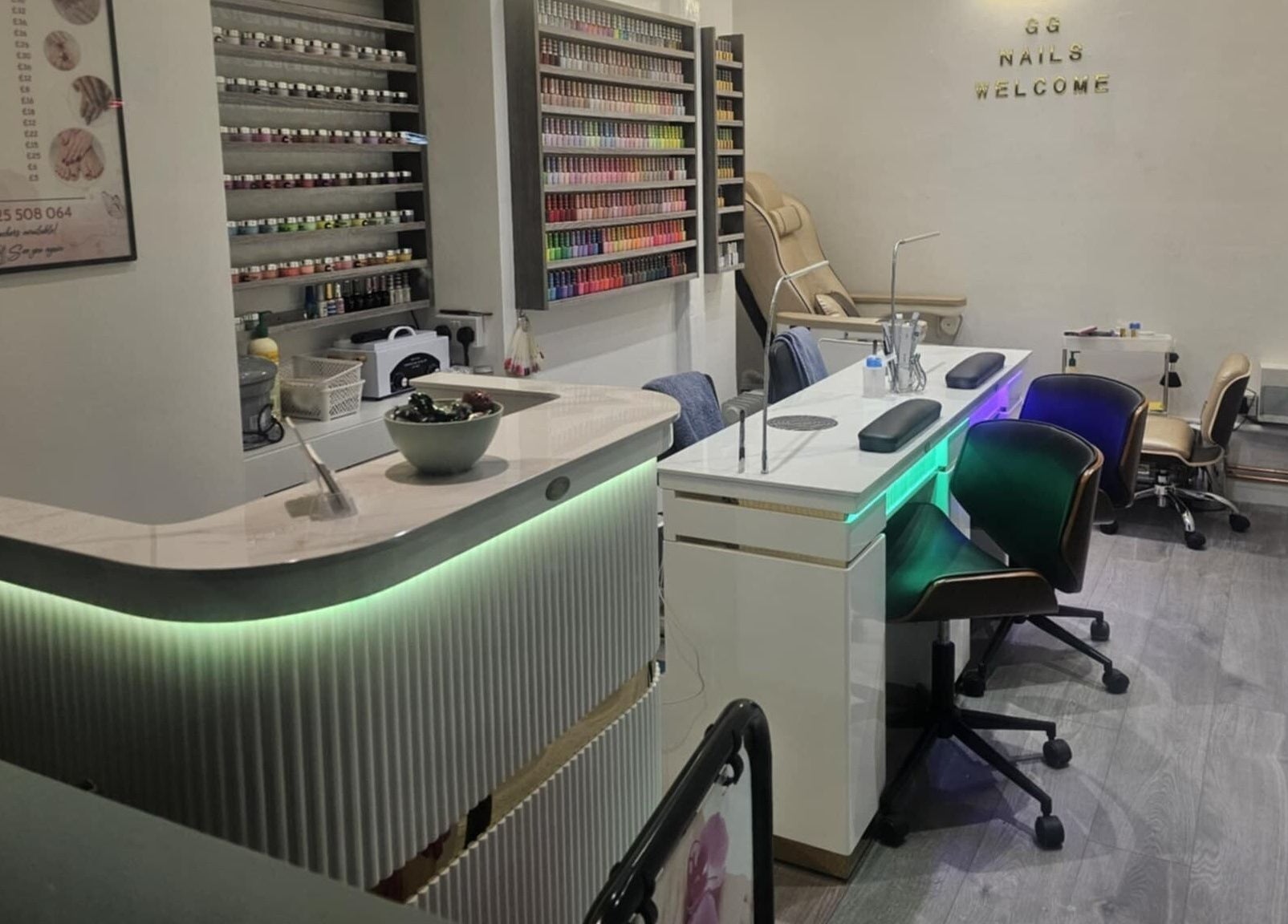 Elegant interior of Gg Nails Rottingdean, Brighton And Hove, England, GB showcasing nail polish display and manicure stations.