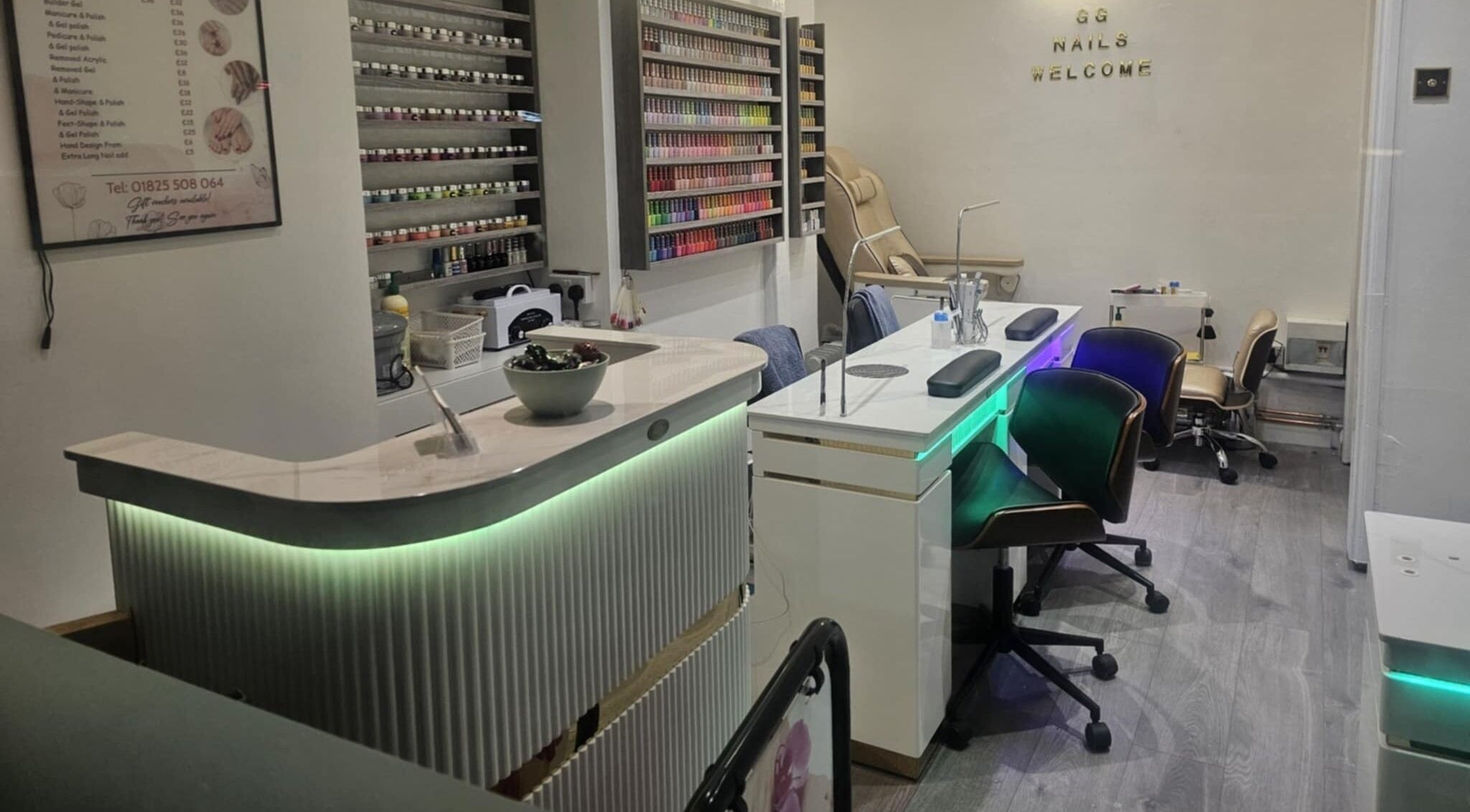 Elegant interior of Gg Nails Rottingdean, Brighton And Hove, England, GB showcasing nail polish display and manicure stations.