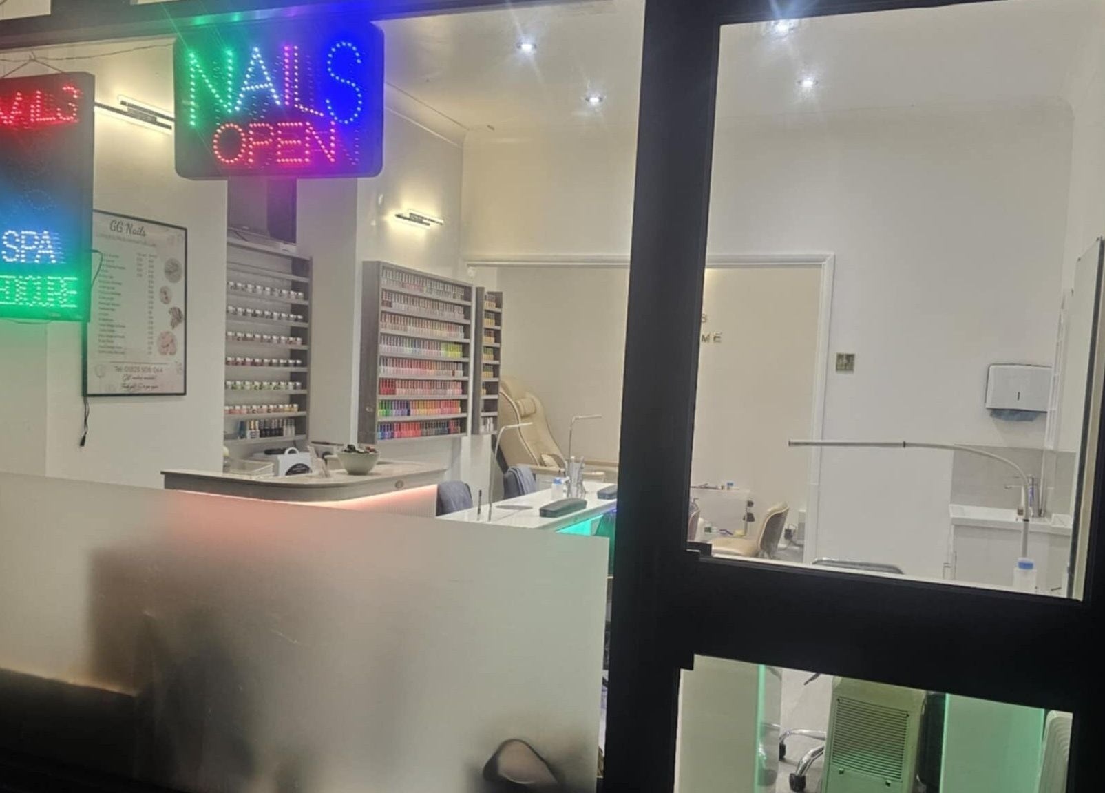 Interior view of Gg Nails Rottingdean showcasing nail polish display at Brighton And Hove, England, GB.