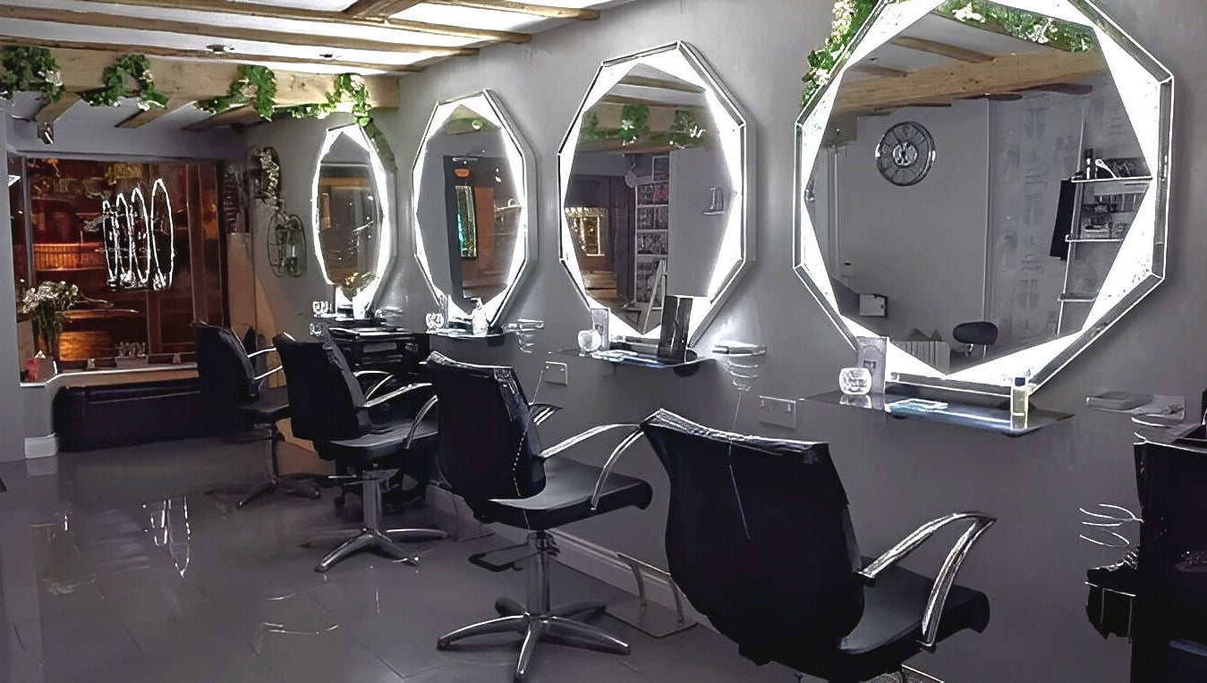 Chic styling stations at Mirror Mirror, Worcester, England, GB, featuring illuminated mirrors and sleek chairs.