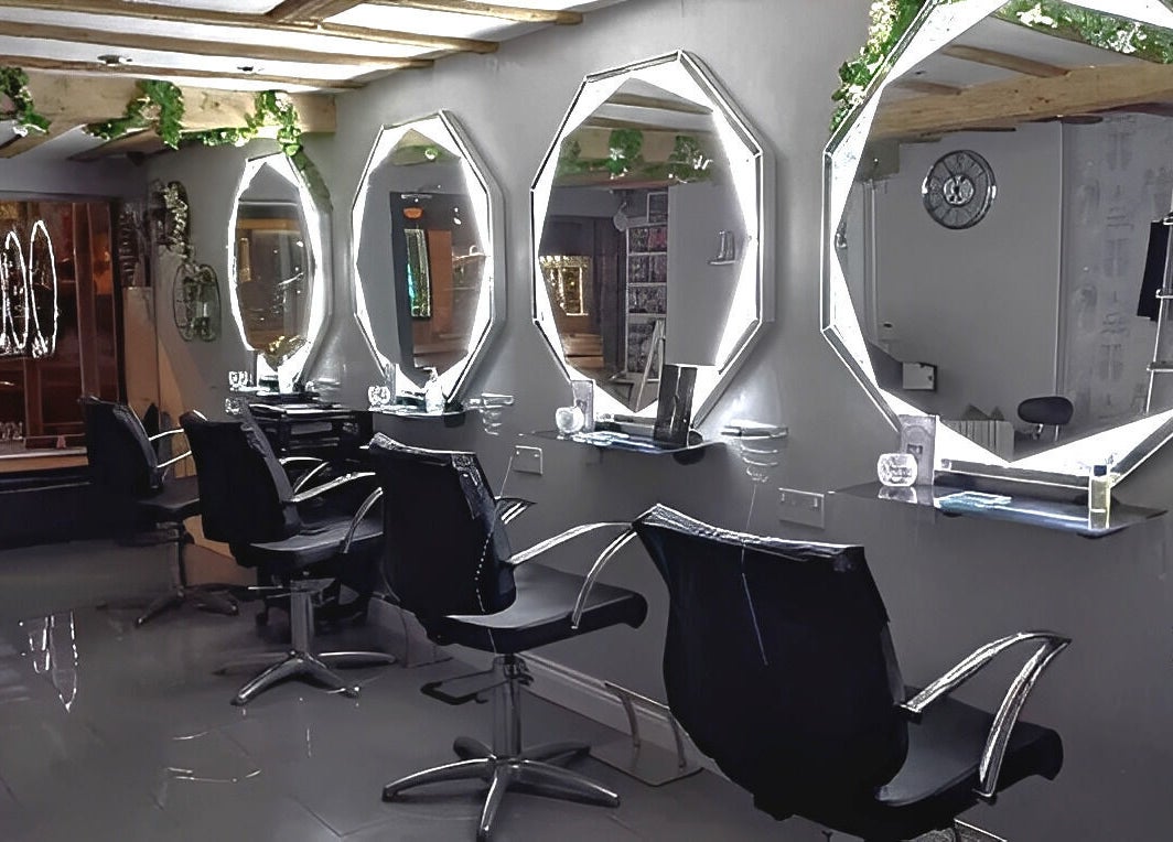 Chic styling stations at Mirror Mirror, Worcester, England, GB, featuring illuminated mirrors and sleek chairs.