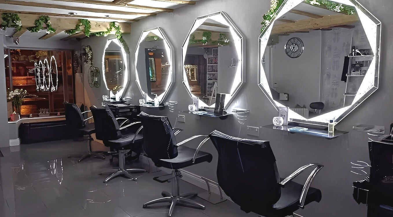 Chic styling stations at Mirror Mirror, Worcester, England, GB, featuring illuminated mirrors and sleek chairs.