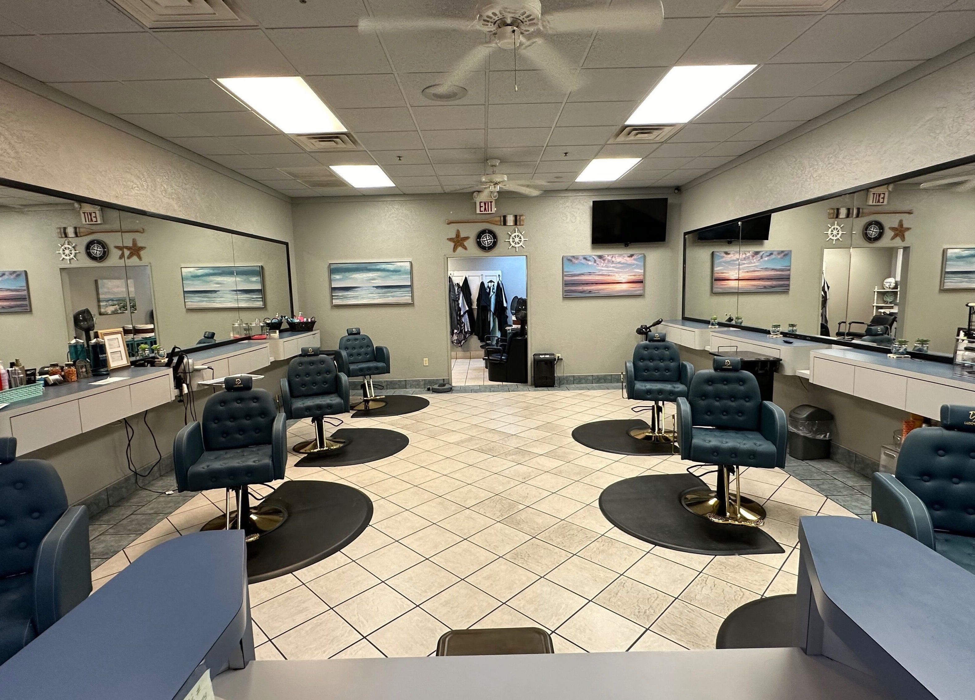 Spacious interior of The Wave Salon in Broken Arrow, Oklahoma, US with stylist stations and artwork.