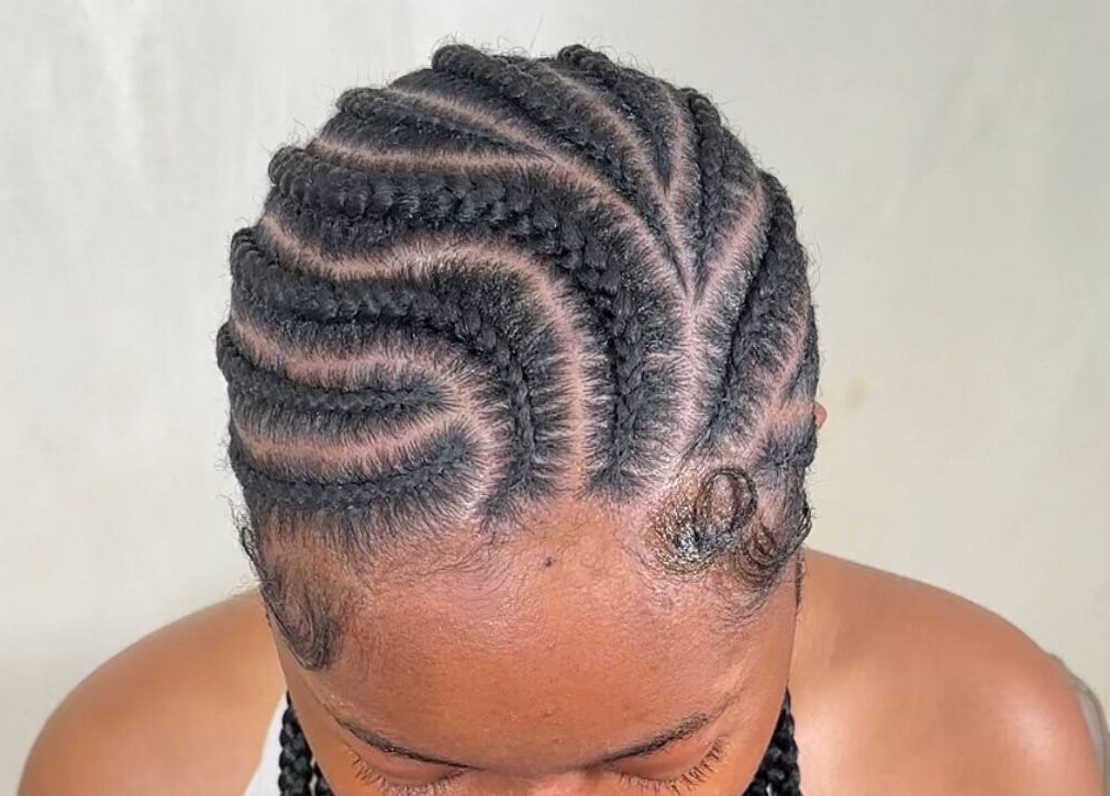 Intricate braided hairstyle at M London Studios, Barking, England, GB showcasing stylish cornrows.