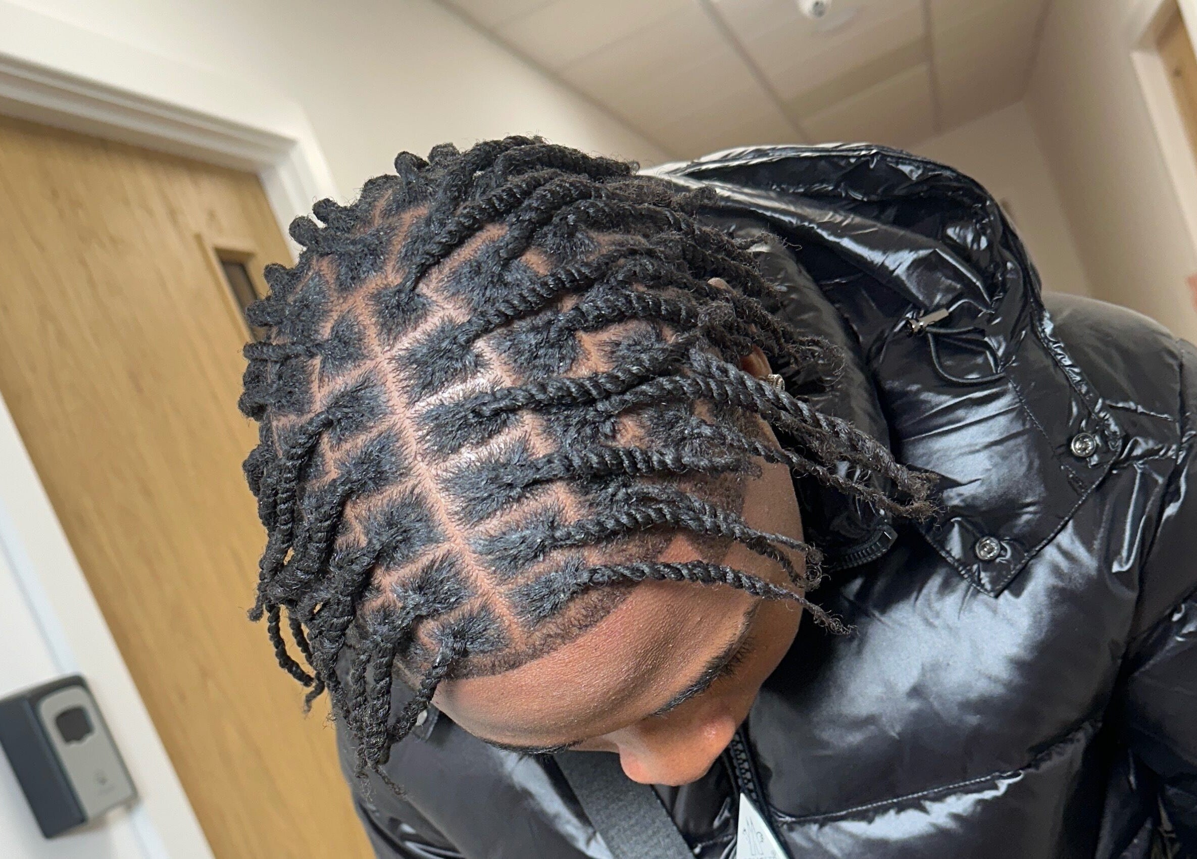 Intricate twisted hairstyle at M London Studios, Barking, England, GB, showcasing expert styling.