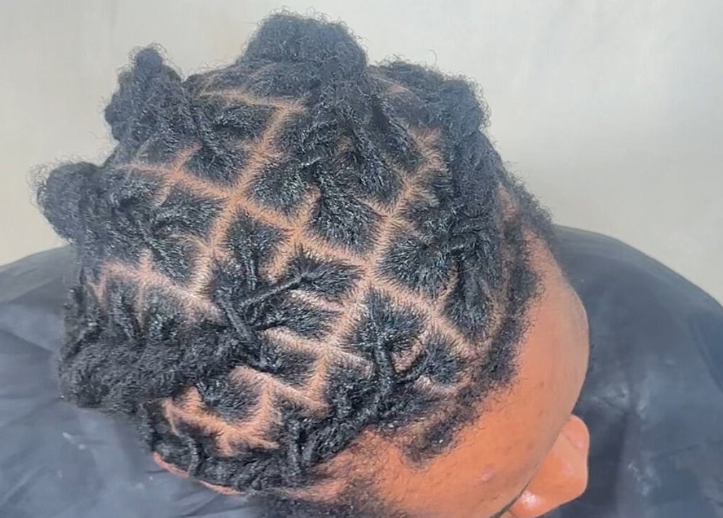 Detailed natural hair styling at M London Studios, located in Barking, England, GB, showcasing expert technique.