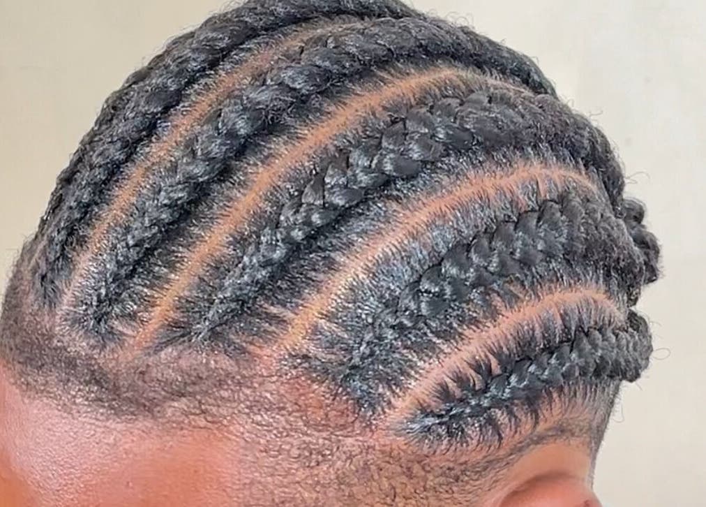 Intricate braided hairstyle at M London Studios, Barking, England, GB, showcasing expert styling.