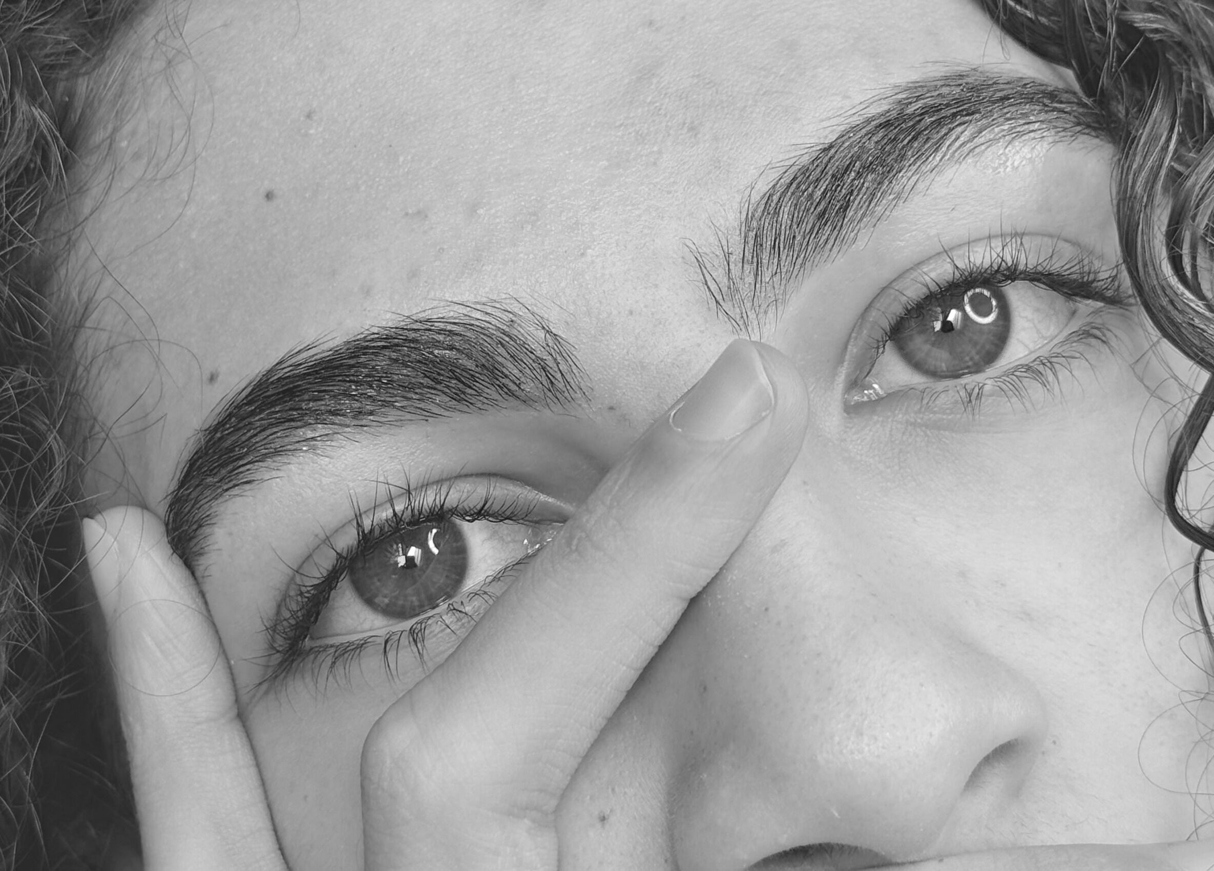 Close-up of a person's eye with curly hair at Gely Precious, Colorado Springs, Colorado, US.