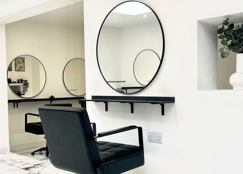 Modern salon interior with sleek decor at SHADE ANDOVER, Andover, England, GB, featuring stylish mirrors and seating.
