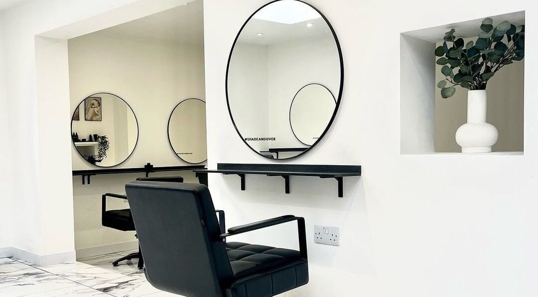 Modern salon interior with sleek decor at SHADE ANDOVER, Andover, England, GB, featuring stylish mirrors and seating.