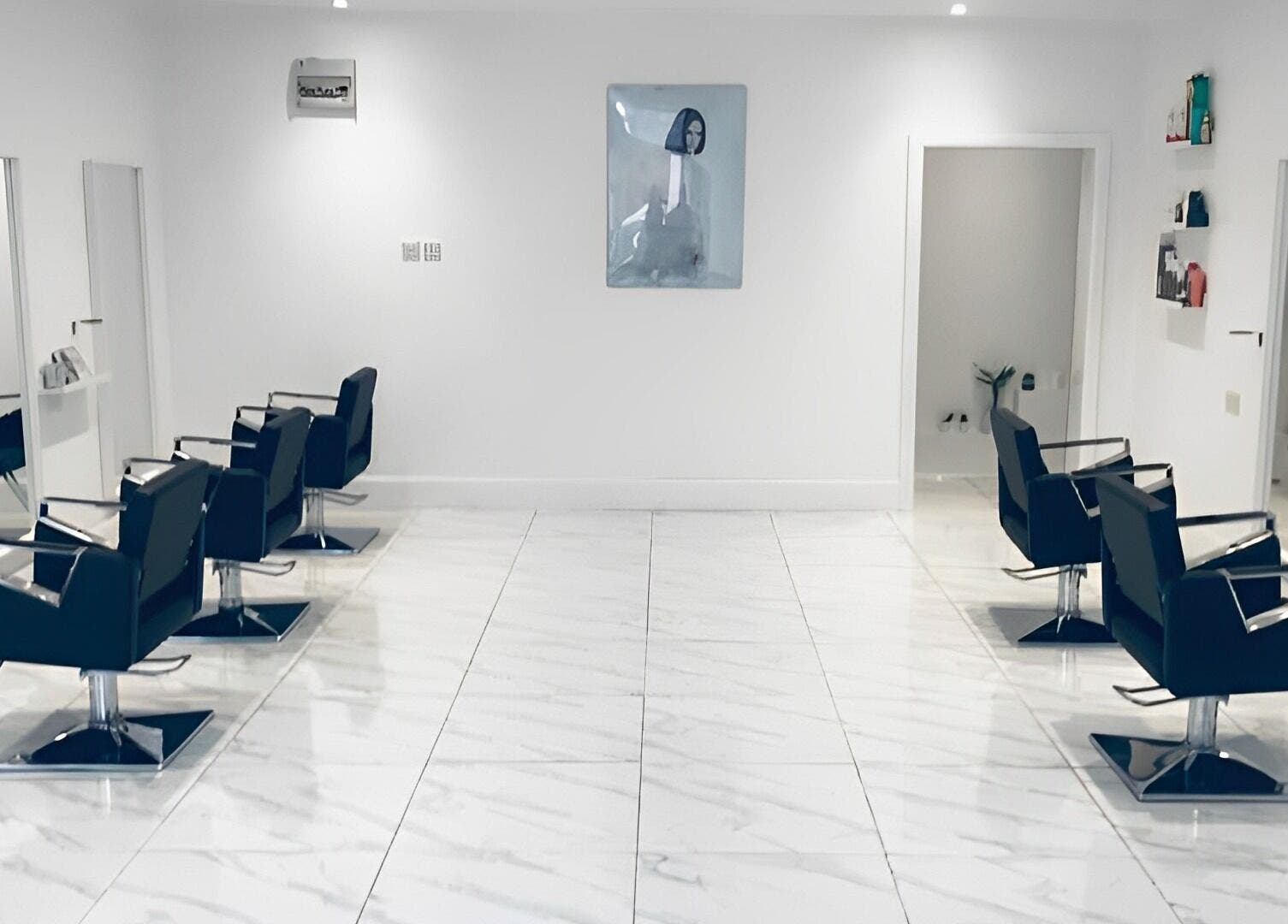 Modern salon interior with sleek styling chairs at SHADE ANDOVER, Andover, England, GB.
